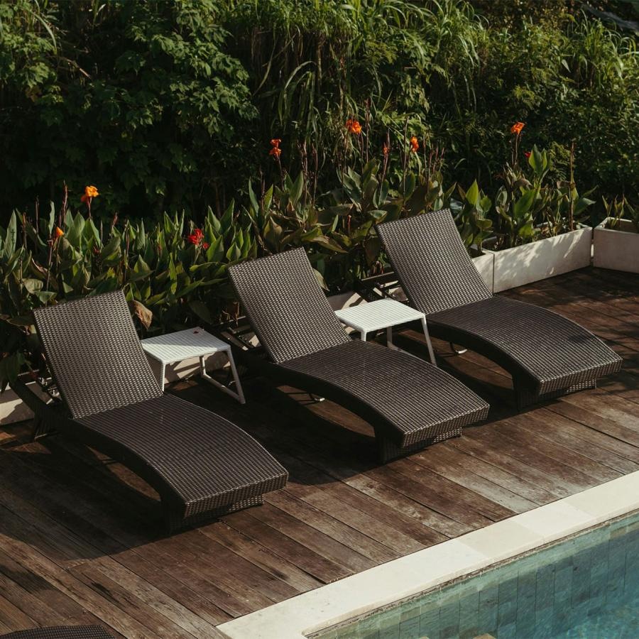 a group of chairs around a pool