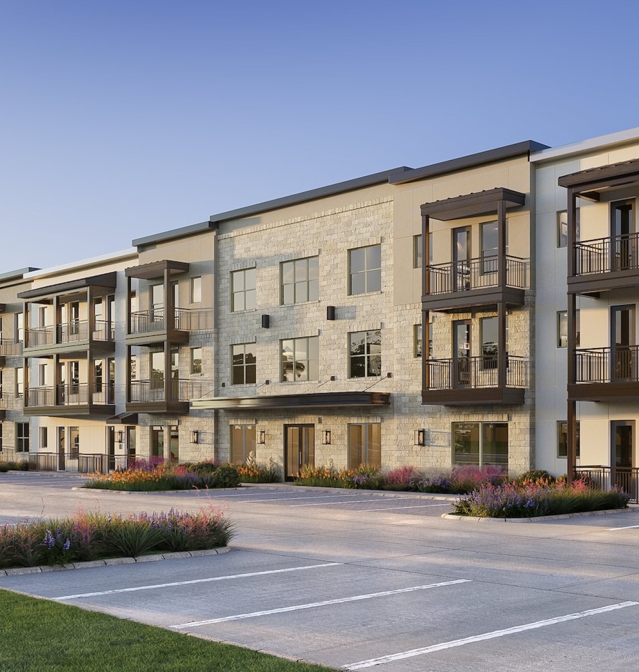 a large building with many windows and parking lot